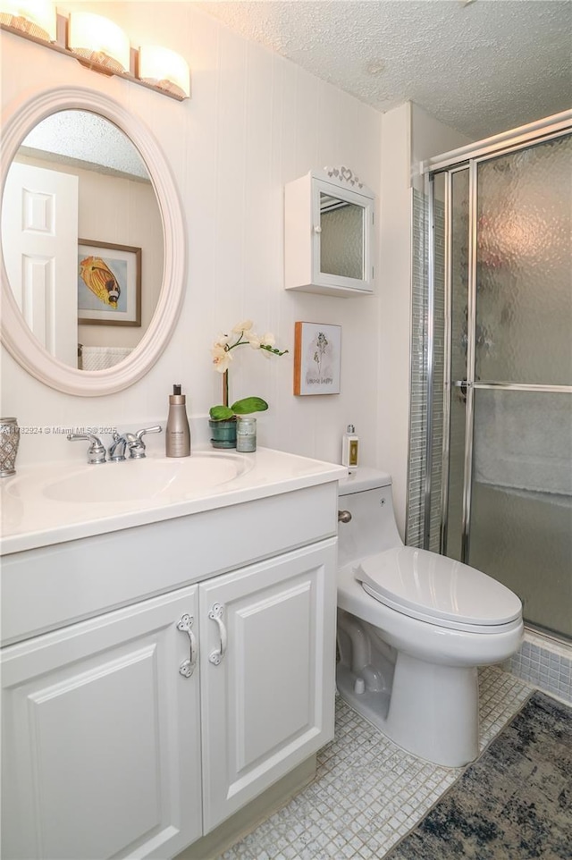 581 Blue Heron Dr Unit 112-B, Hallandale Beach, FL 33009 - full bath with toilet, vanity, a textured ceiling, and a stall shower
