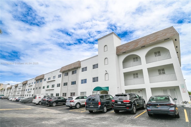 581 Blue Heron Dr Unit 112-B, Hallandale Beach, FL 33009 - view of building exterior with uncovered parking