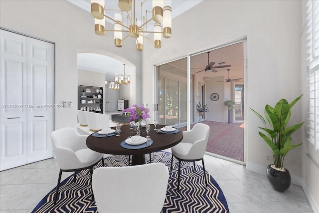 12580 NW 76th St, Parkland, FL 33076 - dining area with a chandelier, arched walkways, light tile patterned floors, a ceiling fan, and baseboards