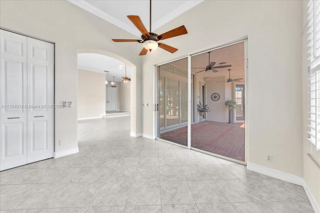 12580 NW 76th St, Parkland, FL 33076 - unfurnished room featuring ceiling fan, arched walkways, crown molding, light tile patterned floors, and baseboards