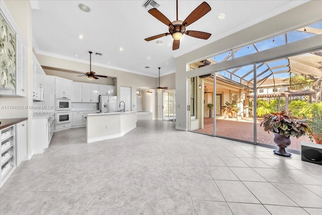 12580 NW 76th St, Parkland, FL 33076 - kitchen with white appliances, a ceiling fan, ornamental molding, a sink, and white cabinetry