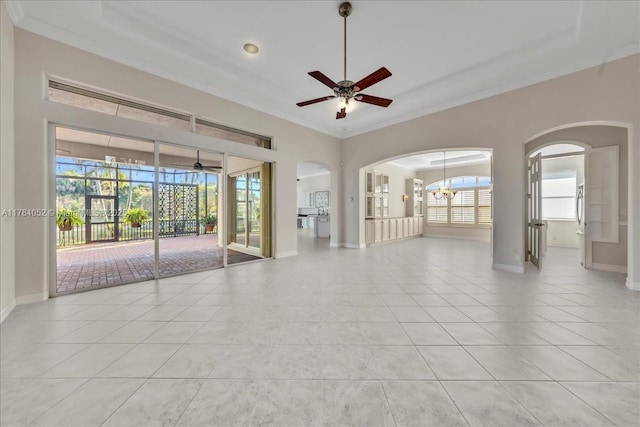 12580 NW 76th St, Parkland, FL 33076 - empty room with ornamental molding, ceiling fan, healthy amount of natural light, arched walkways, and light tile patterned flooring