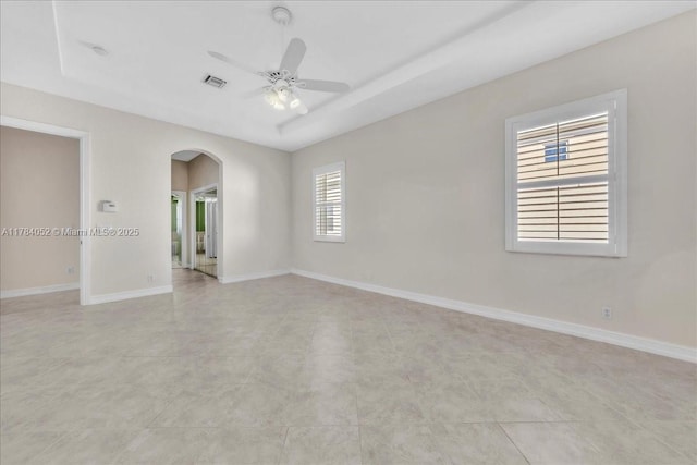 12580 NW 76th St, Parkland, FL 33076 - empty room featuring arched walkways, ceiling fan, and baseboards