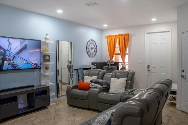 living room featuring light tile patterned flooring, visible vents, and recessed lighting