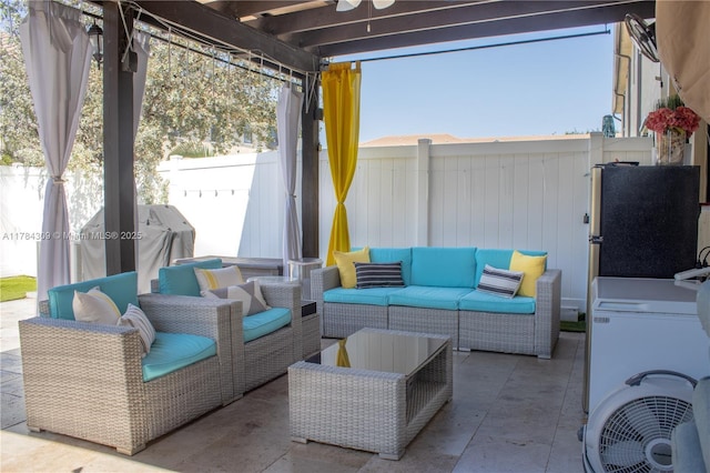 view of patio / terrace featuring a fenced backyard, washer / dryer, and an outdoor hangout area