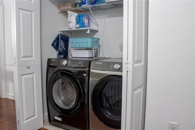laundry room featuring separate washer and dryer and laundry area