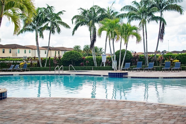 view of pool with a patio area and fence