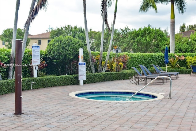 view of pool with a community hot tub and a patio