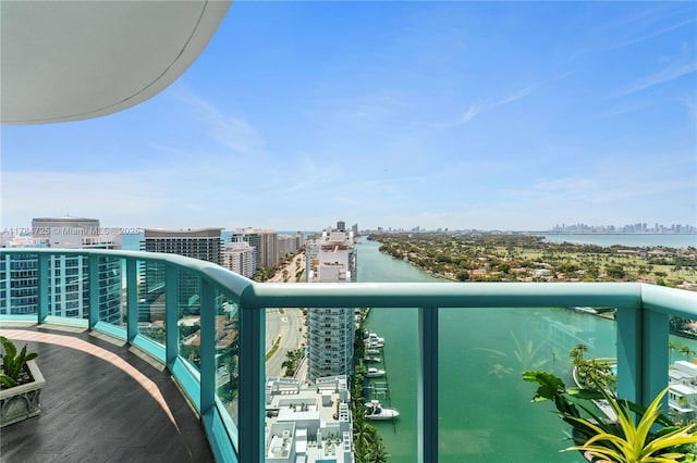 balcony featuring a water view and a view of city