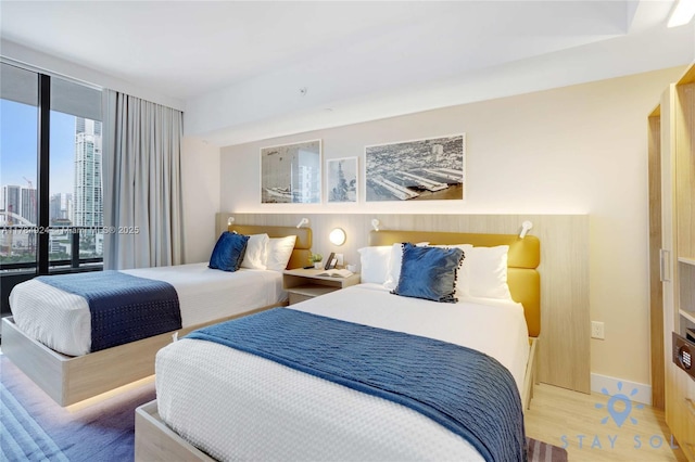 601 NE 1st Ave Unit 1602, Miami, FL 33132 - bedroom featuring wood finished floors, a view of city, and baseboards