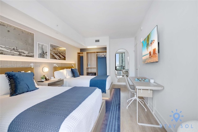 601 NE 1st Ave Unit 1602, Miami, FL 33132 - bedroom featuring visible vents, baseboards, a closet, and wood finished floors