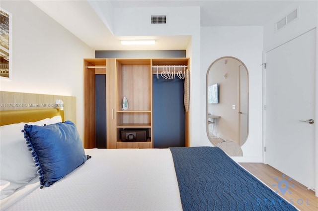 601 NE 1st Ave Unit 1602, Miami, FL 33132 - bedroom with visible vents, a closet, and wood finished floors