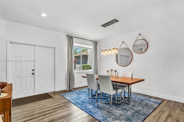 dining area featuring baseboards and wood finished floors