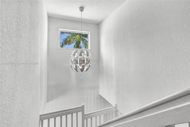 room details featuring a textured wall and a textured ceiling