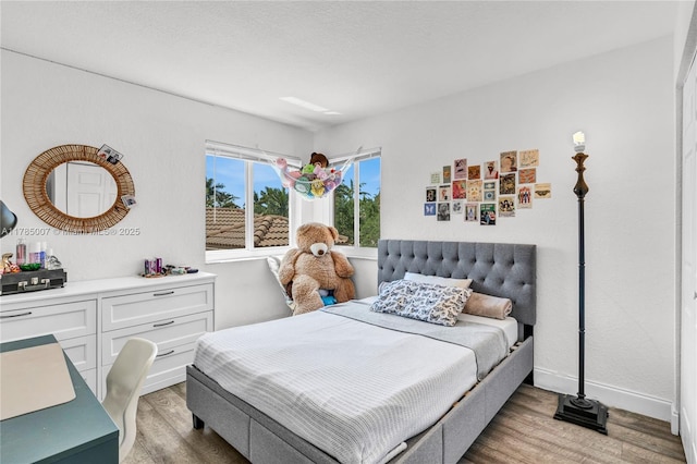 bedroom with wood finished floors