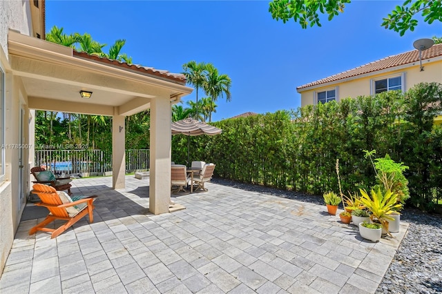 view of patio / terrace with outdoor dining space and fence