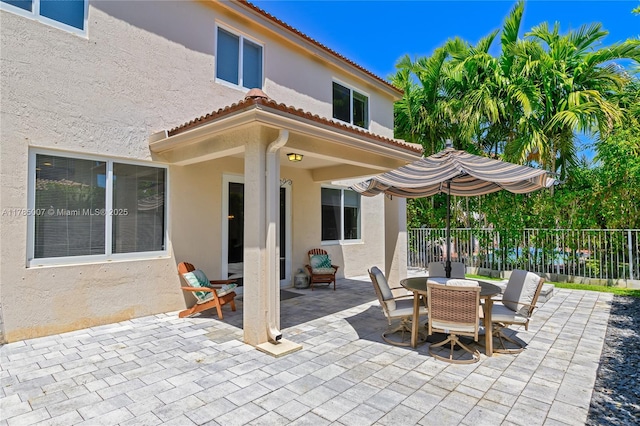 view of patio / terrace featuring fence and outdoor dining area