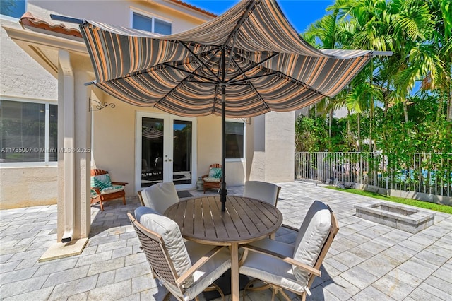 view of patio / terrace featuring french doors and fence