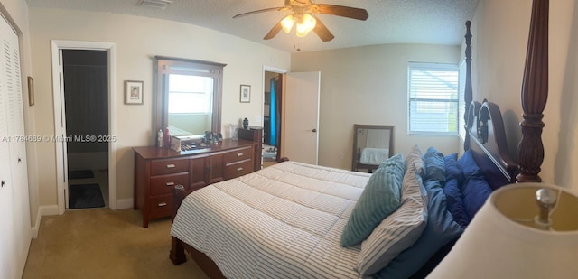 bedroom featuring light colored carpet, a ceiling fan, and baseboards