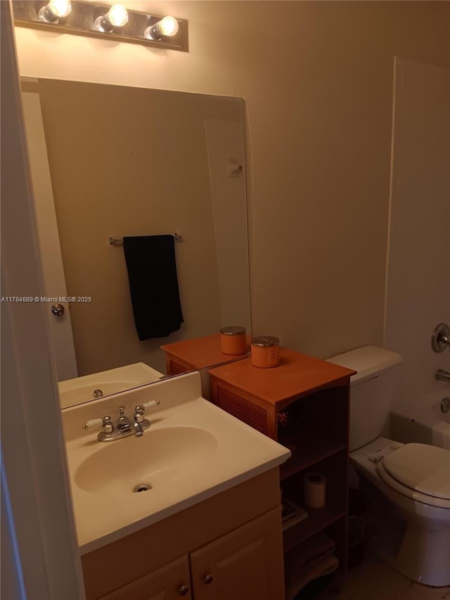 bathroom with vanity, toilet, and bathtub / shower combination