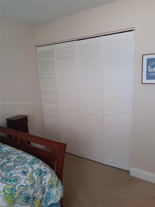 carpeted bedroom with a closet