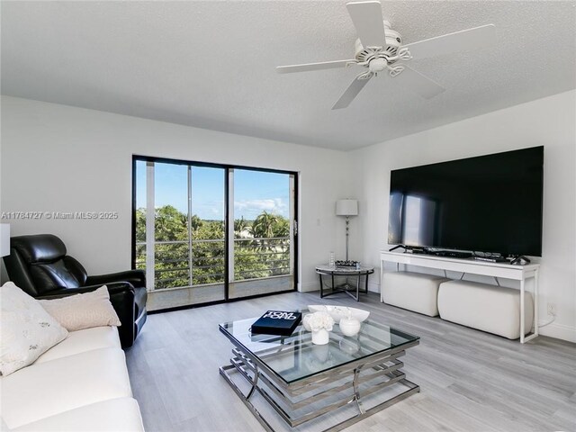 1425 Atlantic Shores Blvd Unit 605, Hallandale Beach, FL 33009 - living room with ceiling fan, a textured ceiling, wood finished floors, and baseboards