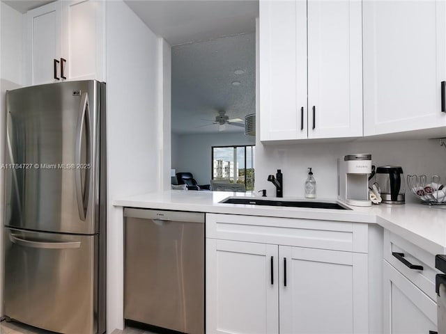 1425 Atlantic Shores Blvd Unit 605, Hallandale Beach, FL 33009 - kitchen with light countertops, white cabinetry, ceiling fan, stainless steel appliances, and a sink