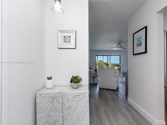 1425 Atlantic Shores Blvd Unit 605, Hallandale Beach, FL 33009 - hall featuring a textured ceiling, baseboards, and wood finished floors