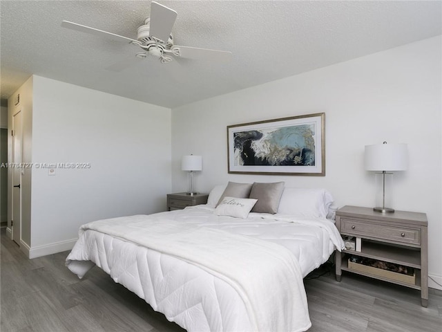 1425 Atlantic Shores Blvd Unit 605, Hallandale Beach, FL 33009 - bedroom featuring ceiling fan, baseboards, a textured ceiling, and wood finished floors