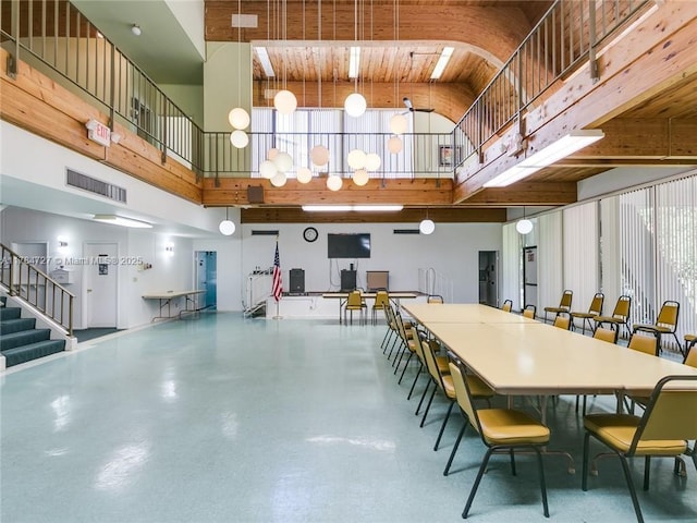 1425 Atlantic Shores Blvd Unit 605, Hallandale Beach, FL 33009 - dining area featuring visible vents, stairway, and a towering ceiling