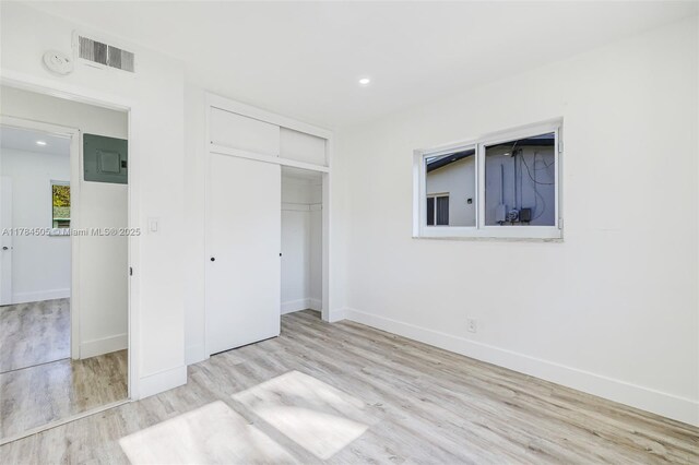 221 SW 28th Ter, Fort Lauderdale, FL 33312 - unfurnished bedroom with wood finished floors, baseboards, a closet, and visible vents