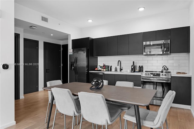 398 NE 5th St Unit 2419, Miami, FL 33132 - kitchen with visible vents, a sink, dark cabinetry, and appliances with stainless steel finishes