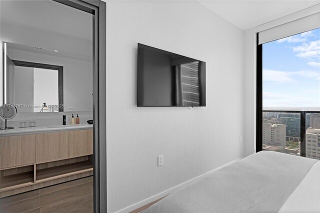 398 NE 5th St Unit 2419, Miami, FL 33132 - bedroom featuring a sink, multiple windows, baseboards, and a wall of windows