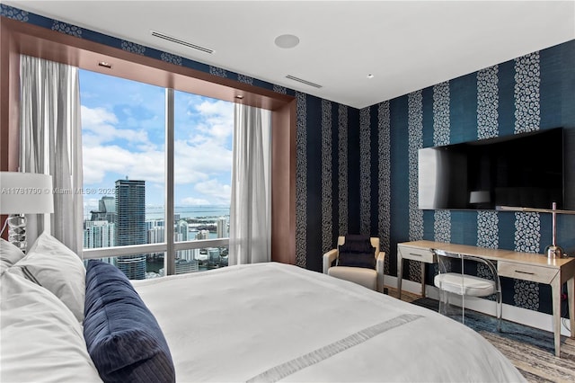 bedroom with visible vents and wallpapered walls