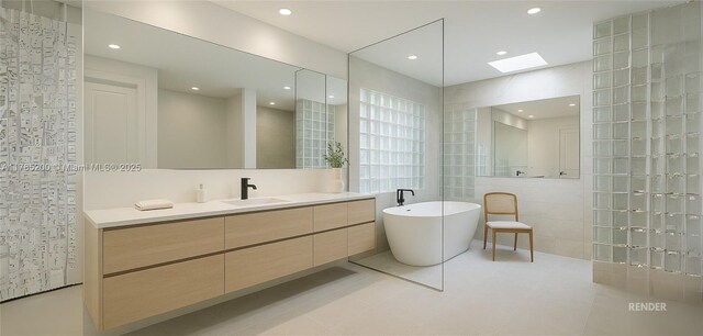 bathroom featuring tile walls, a freestanding tub, vanity, tile patterned flooring, and a skylight