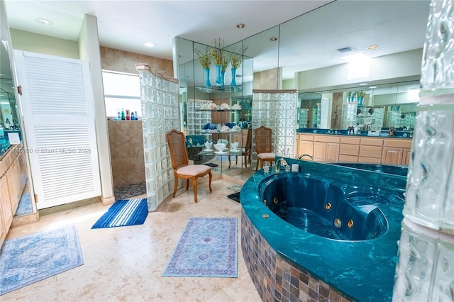 full bathroom featuring walk in shower, a whirlpool tub, and vanity