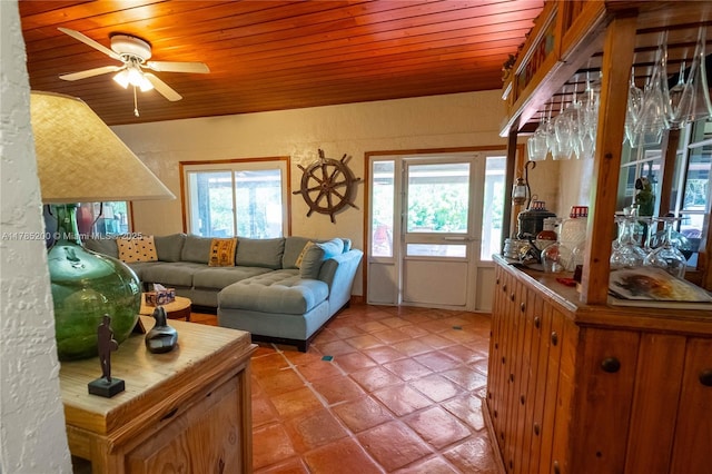 living room with wooden ceiling, a ceiling fan, light tile patterned floors, a textured wall, and lofted ceiling