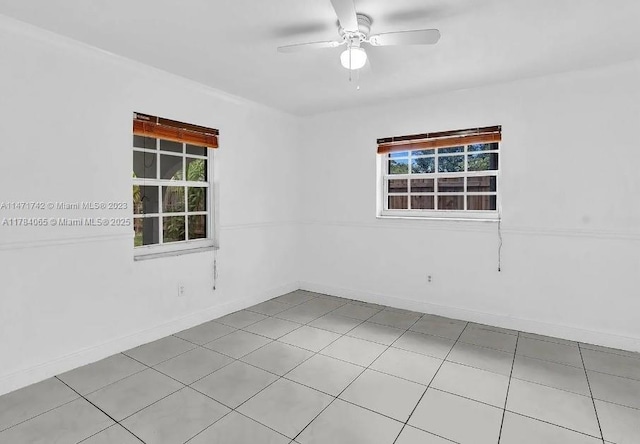 unfurnished room featuring baseboards and a ceiling fan