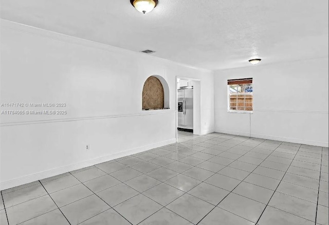 unfurnished room with visible vents and baseboards