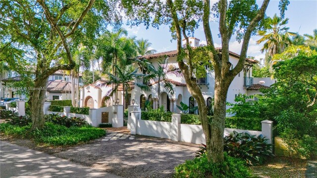1511 Alegriano Ave, Coral Gables, FL 33146 - mediterranean / spanish house with stucco siding, a tile roof, and a fenced front yard