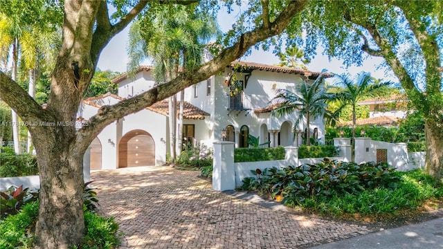 1511 Alegriano Ave, Coral Gables, FL 33146 - mediterranean / spanish-style home featuring stucco siding, decorative driveway, a garage, and fence private yard