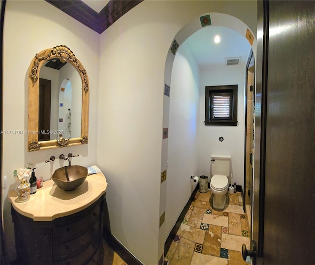 1511 Alegriano Ave, Coral Gables, FL 33146 - bathroom featuring vanity, baseboards, toilet, stone tile flooring, and visible vents