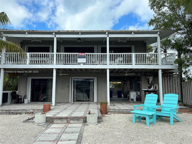 rear view of property with a patio, fence, a ceiling fan, and a balcony