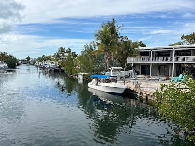 view of dock featuring a water view and a patio area