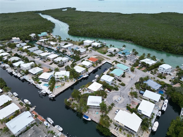 bird's eye view featuring a water view, a residential view, and a wooded view