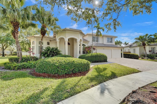 1951 NW 167th Ter, Pembroke Pines, FL 33028 - mediterranean / spanish home featuring an attached garage, driveway, a front yard, and stucco siding