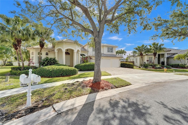 1951 NW 167th Ter, Pembroke Pines, FL 33028 - mediterranean / spanish-style house with stucco siding, driveway, and a garage