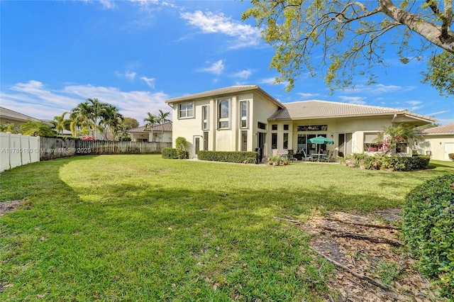 1951 NW 167th Ter, Pembroke Pines, FL 33028 - rear view of house with a fenced backyard, a tile roof, stucco siding, and a lawn