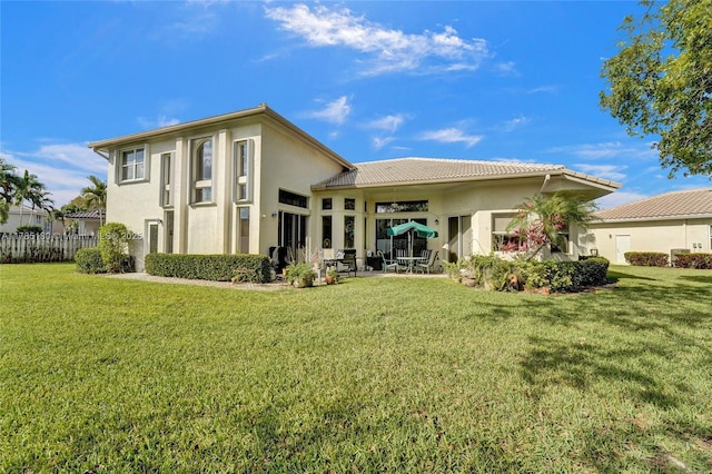 1951 NW 167th Ter, Pembroke Pines, FL 33028 - rear view of house with a lawn, fence, a patio area, and stucco siding