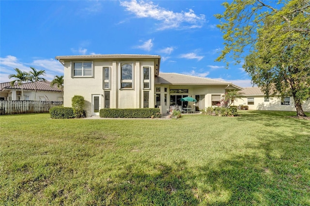 1951 NW 167th Ter, Pembroke Pines, FL 33028 - back of property featuring a lawn, a tile roof, fence, and stucco siding